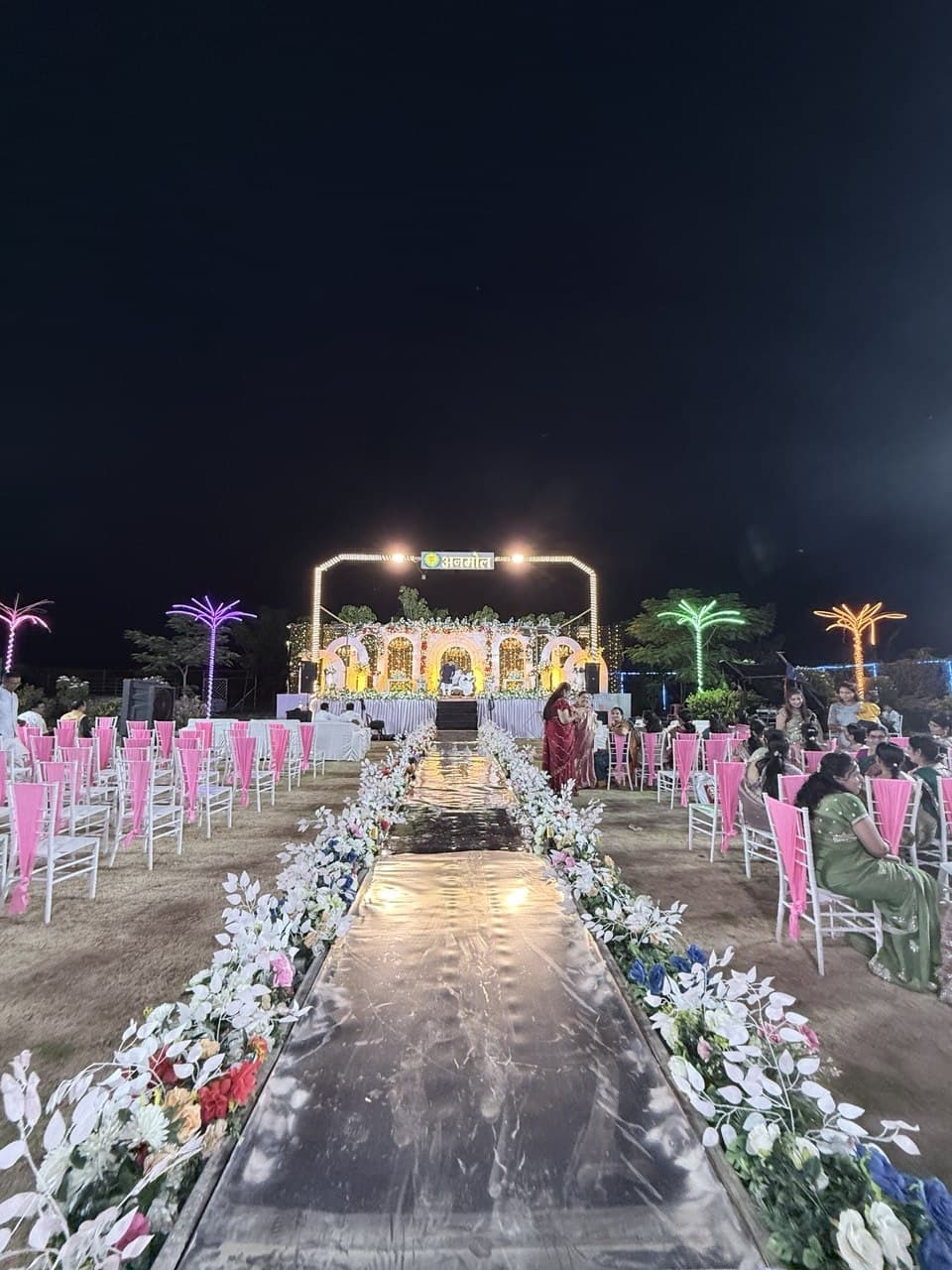 Bride under floral arch at Anmol Lawns